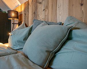Pillows and bedding in the bedroom of Spoiled Wheel vacation home in Callantsoog.
