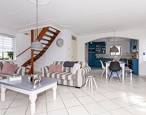 Cozy living room in the Detached house in Callantsoog, North Sea coast, with comfortable sofas and an open kitchen in North Holland.