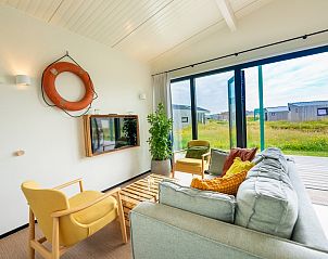 Cozy sitting area of Royal Dune 4 in Callantsoog overlooking the North Sea coast.