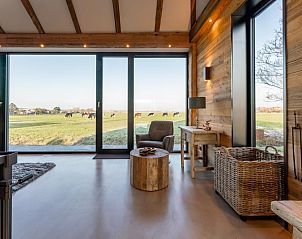 Spacious living room with panoramic views in De Bonte Specht vacation home, Callantsoog.