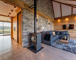 Modern living room and kitchen in De Bonte Specht vacation home, Callantsoog, North Holland.