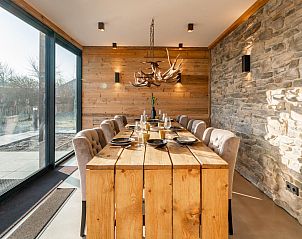 Cozy dining room with wooden details in De Bonte Specht vacation home, Callantsoog, North Holland.