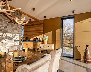 Dining area in De Bonte Specht vacation home with natural light, Callantsoog, North Sea coast.
