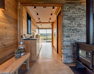 Functional kitchen in De Bonte Specht vacation home, Callantsoog, overlooking the garden.