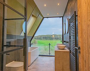 Modern bathroom with freestanding bath in De Bonte Specht vacation home, Callantsoog, North Sea coast.