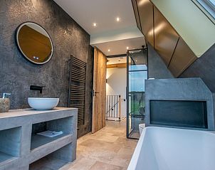 Bright bedroom with large windows in De Bonte Specht vacation home, Callantsoog, North Holland.