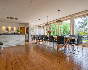 Ruime eetkamer in Landhuis Duinzicht, vakantiehuis in Callantsoog, Noordzeekust. Geniet van het uitzicht op de natuur vanuit deze lichte binnenruimte.