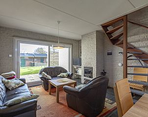 Bright living room with sliding door to garden in vacation home Abbestederweg 24A Callantsoog
