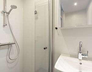 Shower and sink in the bathroom of Abbestederweg 24A Callantsoog vacation home