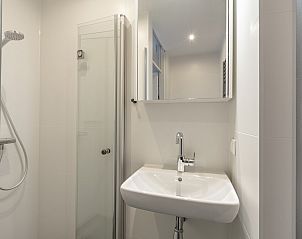 Shower and mirror in the bathroom of Abbestederweg 24A Callantsoog vacation home
