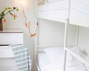Bedroom with bunk beds in Holiday home in Callantsoog, North Sea coast, North Holland, with colorful flowers.
