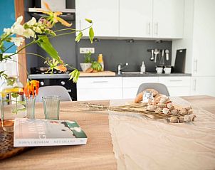 Kitchen of Holiday Home in Callantsoog, North Sea Coast, North Holland, with modern appliances and flowers.