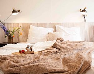 Cozy bedroom in Holiday home in Callantsoog, North Sea coast, North Holland, with soft blankets.