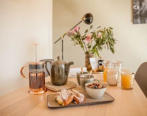 Breakfast on the table at Huisje in Callantsoog, vacation home on the North Sea coast in North Holland.