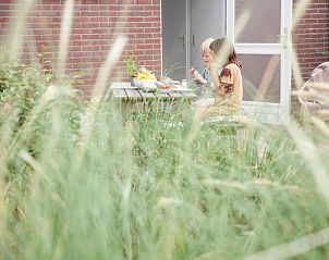 Children enjoy the garden at Huisje in Callantsoog, vacation home on the North Sea coast in North Holland.