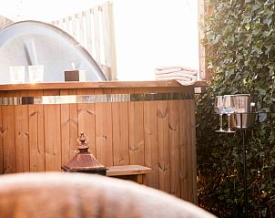 Cozy outdoor area with jacuzzi at Huisje in Callantsoog, vacation home on the North Sea coast in North Holland.