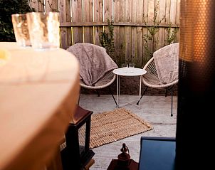 Intimate sitting area outside at Huisje in Callantsoog, vacation home on the North Sea coast in North Holland.
