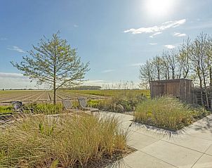 Sunny terrace at Cottage in Callantsoog, vacation home on the North Sea coast overlooking nature.