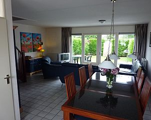 Dining room overlooking garden in Zwanenwater 1 vacation home, Callantsoog, North Sea coast, North Holland.