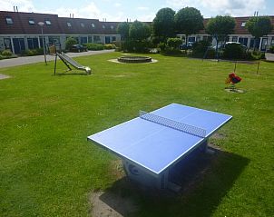 Outdoor playground with table tennis table at Zwanenwater 1 vacation home, Callantsoog, North Sea coast, North Holland.