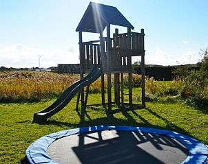 Playground with slide and trampoline at Duinroos Cottage in Egmond aan den Hoef on the North Sea coast, North Holland.