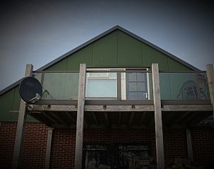 Buitenkant van Vakantiehuisje in Burgerbrug met balkon, Noordzeekust, Noord-Holland.