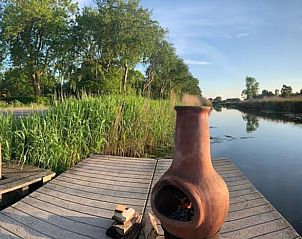 Pittoresk uitzicht op het water bij Huisje in Schagerbrug, Noordzeekust, perfect voor een avond bij het haardvuur.