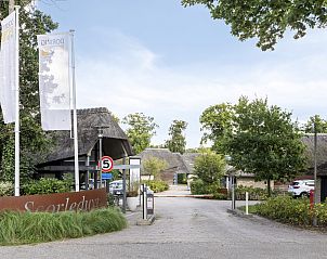 Entrance to Detached house in Schoorl, a vacation home in North Holland, surrounded by green nature and rustic charm.