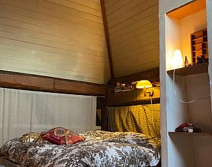 Knusse slaapkamer met houten balken in Huisje in Schoorl, vakantiehuis in Noord-Holland noord.