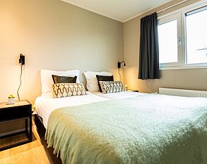 Cozy bedroom in Leijhoeve vacation home for 4 people in Berkhout, North Holland, with comfortable beds and modern interior.