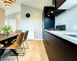 Modern kitchen and dining area in Leijhoeve vacation home for 4 people in Berkhout, North Holland, with stylish dcor and natural light.