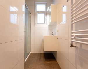 Modern bathroom in Module Special 4-person vacation home in Berkhout, North Holland, with sleek tiles and spacious shower.
