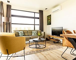 Modern living room in Module Special 4 persons Wellness, a vacation home in Berkhout, North Holland, with spacious seating area and natural light.