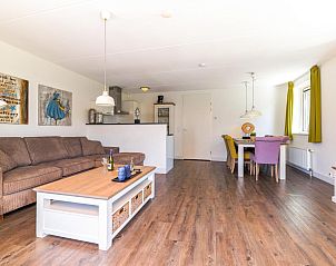 Gezellige woonkamer in vakantiehuis Assum Great in Uitgeest, Noord-Holland, met ruime zithoek en eetgedeelte.