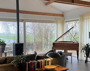 Woonkamer met piano en uitzicht op natuur in Vakantiehuis in Broek in Waterland, Amsterdam eo, Noord-Holland.