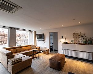 Cozy living room in Holiday Home in Den Ham, Twente, with comfortable seating area and views of the nature of Overijssel.