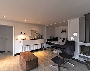 Cozy living room of cottage in Den Ham, Twente, with modern furnishings and comfortable seating area in Overijssel.