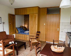 Cozy living room of cottage in Den Ham, Twente. Vacation home with cozy sitting area and kitchen in Overijssel nature.