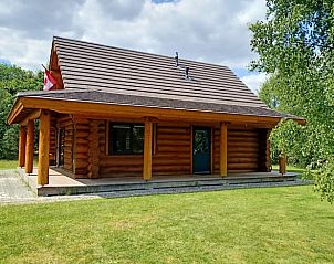 Vakantiehuis in Den Ham, Twente, biedt een rustieke houten lodge-ervaring met een ruime veranda omgeven door groene natuur in Overijssel.
