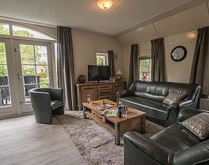 Cozy living room in Holiday Home in Den Ham, Twente, Overijssel with comfortable sofas and views of the green surroundings.