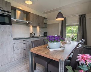 Stylish kitchen and dining area in Holiday home in Den Ham, Twente. Enjoy modern amenities in this cozy vacation home in Overijssel.