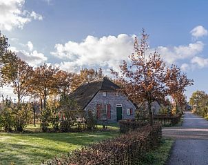 Rustic charm of Holiday Home in Den Ham, nestled in the picturesque landscape of Twente, Overijssel, surrounded by autumnal nature.