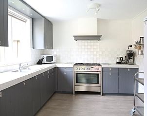 Modern kitchen in Holiday Home in de Lutte, Twente, Overijssel with ample countertops and appliances for a comfortable stay.