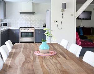 Cozy dining room in Holiday home in de Lutte, Twente, with wooden table and modern kitchen. Perfect for a relaxing stay in Overijssel.