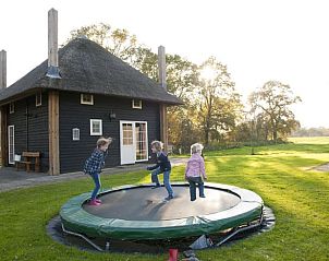 Kinderen spelen op trampoline bij Vakantiehuis in Wierden, ideaal voor een gezinsvakantie in Twente, Overijssel.