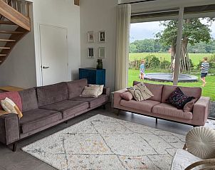 Ruime woonkamer met uitzicht op tuin in Vakantiehuis in Beuningen, Twente, Overijssel.