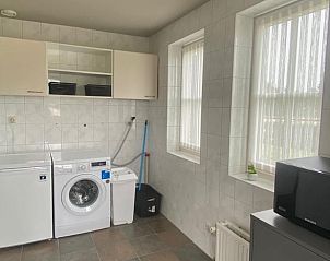 Praktische wasruimte in Huisje in Rijssen, vakantieaccommodatie in Twente, Overijssel, met wasmachine en droger.