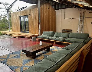 Spacious sitting area with wooden decor in Cottage in Rijssen, vacation accommodation in Twente, Overijssel.