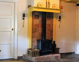 Cozy living room with wood stove in Holiday home in Haaksbergen, Twente, Overijssel for a warm atmosphere during your stay.