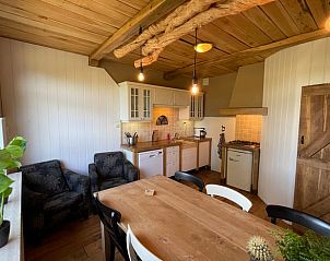Cozy kitchen and dining area in Holiday Home in Markelo, Twente, Overijssel with rustic wooden accents and modern amenities.